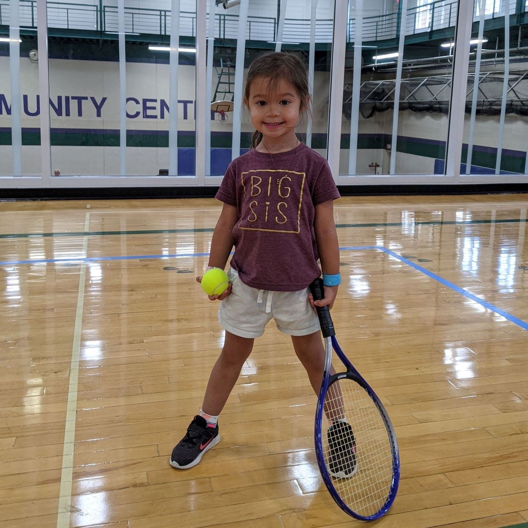 Girl holding tennis racquet 