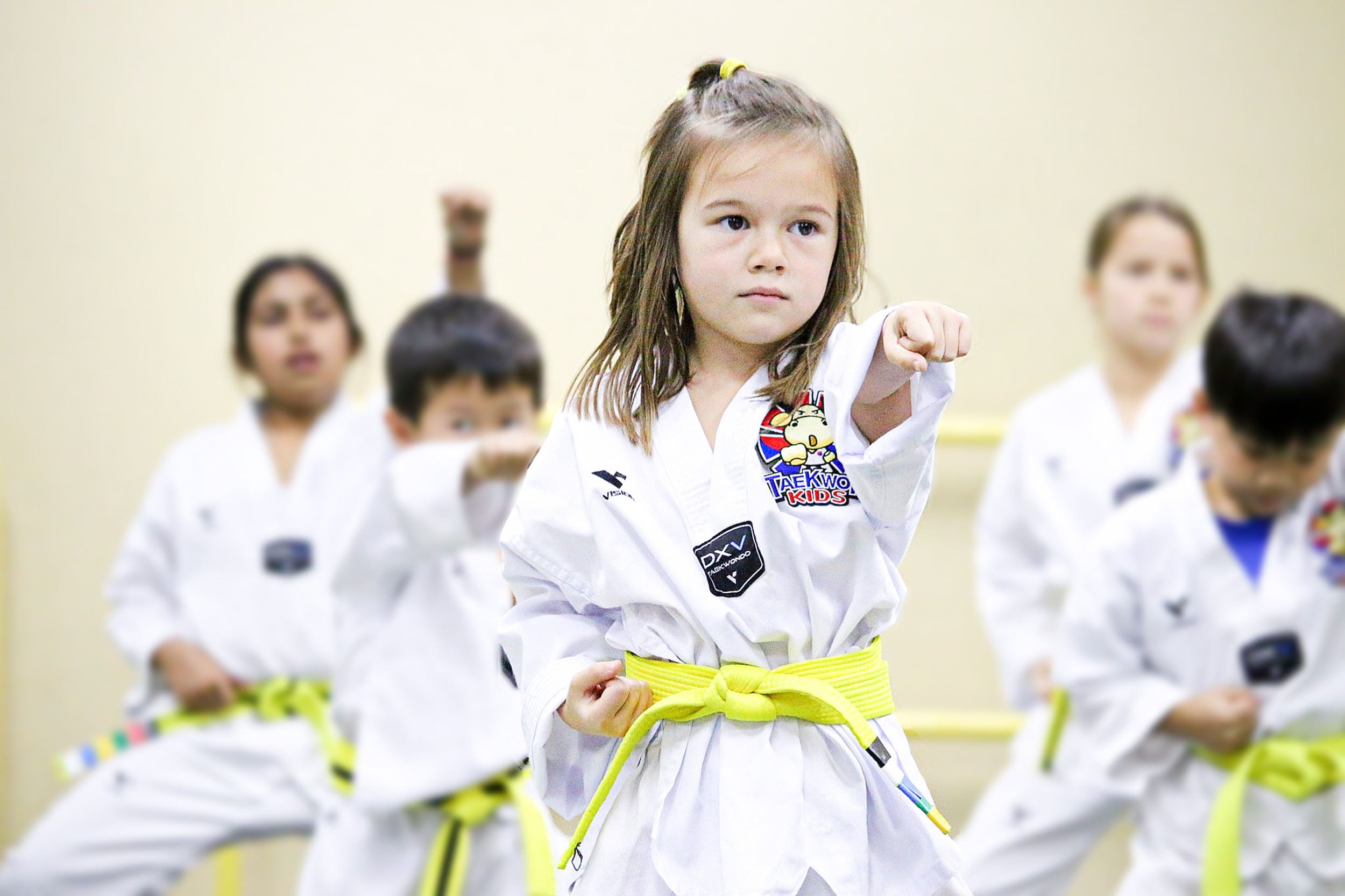 Little girl in yellow Tae Kwon Do belt posing