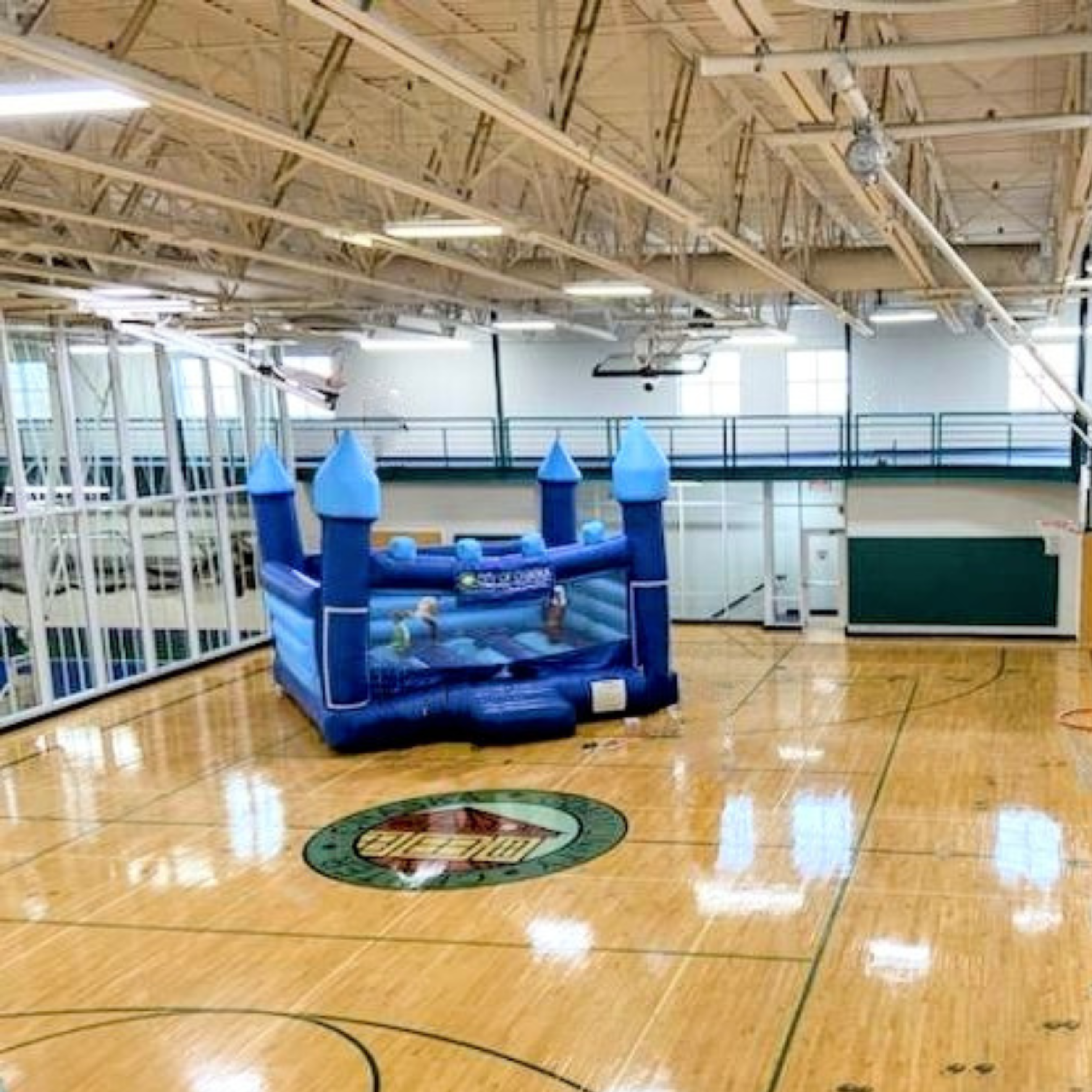 Upper gym with large blue inflatable for the gymazing party