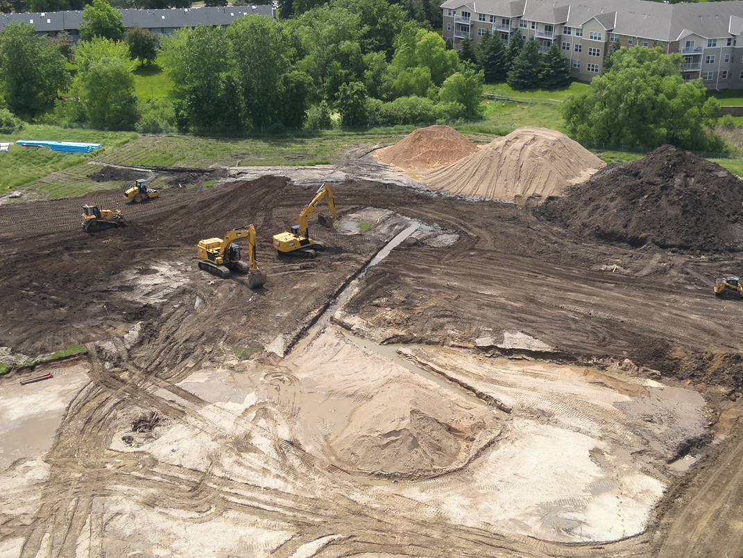View of excavation work with construction equipment moving dirt